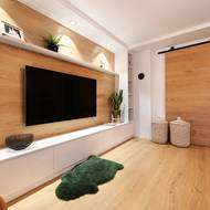 Dubové parkety, které použili na podlaze, se objevují také na stěně za televizorem a jsou z nich vyrobené i masivní posuvné dveře